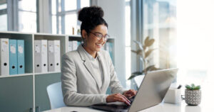 Woman taking on small business administration tasks on her laptop.